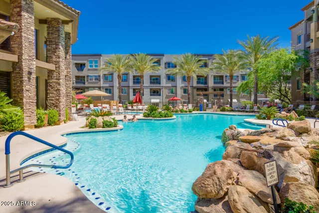 a view of swimming pool with outdoor seating and a yard