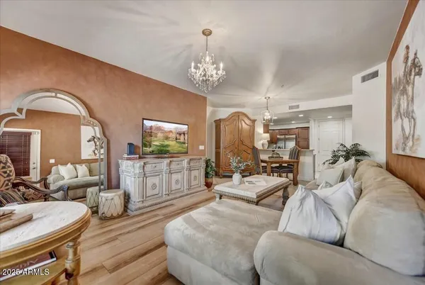 a living room with furniture a rug and a chandelier