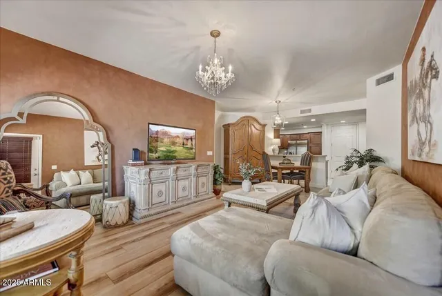 a living room with furniture a rug and a chandelier