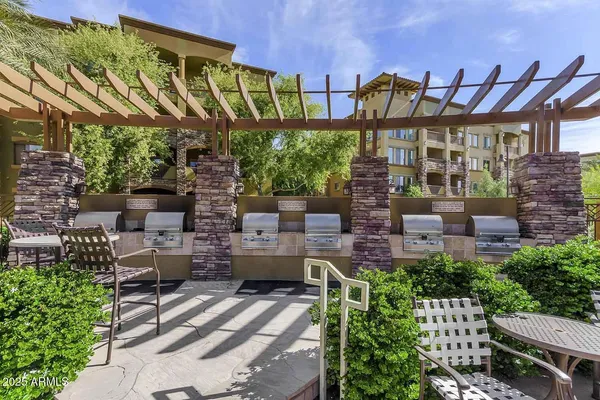 a patio with sofas fire pit and outdoor seating