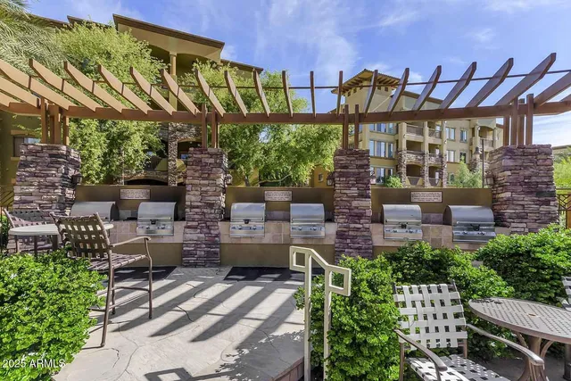 a patio with sofas fire pit and outdoor seating