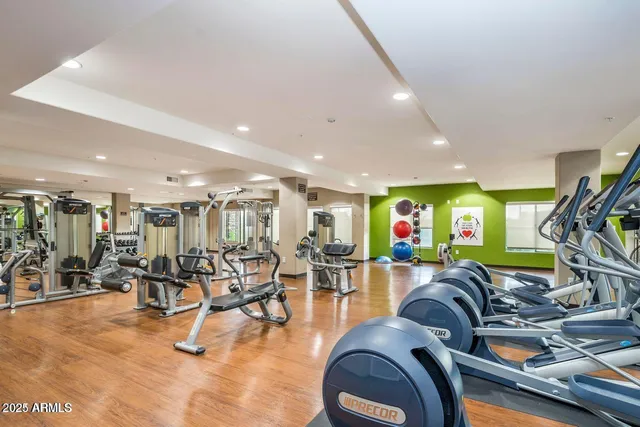 a gym room with lots of gym equipment