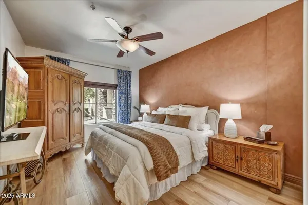 a bedroom with a bed and wooden floor