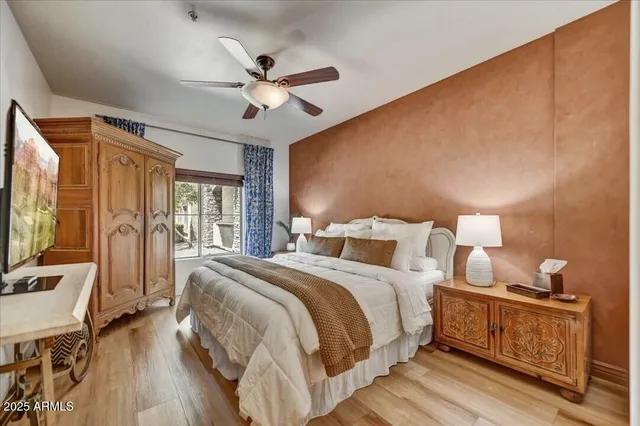 a bedroom with a bed and wooden floor