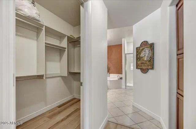 walk in closet with wooden floor