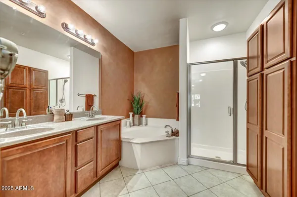 a bathroom with a double vanity sink mirror and bathtub