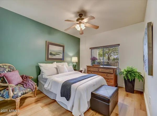a bedroom with a bed and a potted plant