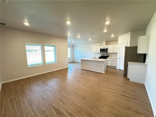 a view of kitchen with sink and wooden floor
