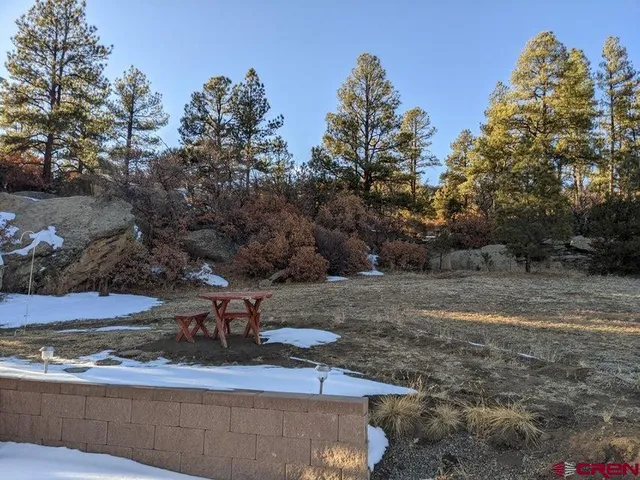 a view of a yard with table and chairs