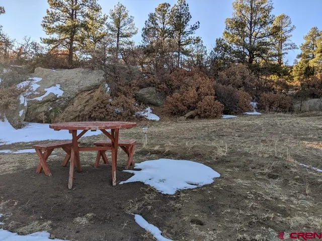 a view of a backyard with table and chairs