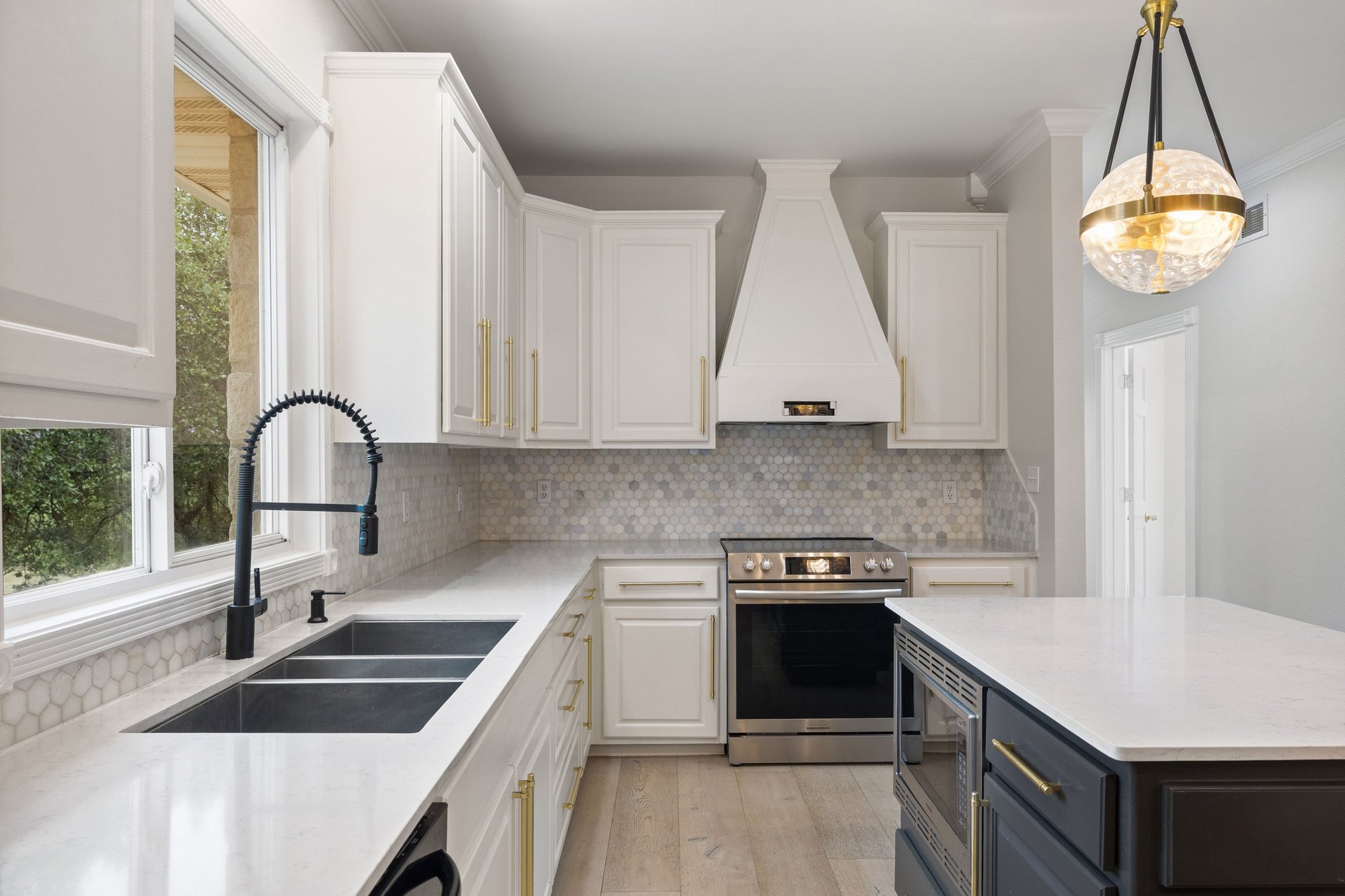 4915 Canyon Ranch Trail Spicewood, TX 78669 - Photo 13 of 40 Quartz counters, honeycomb backsplash and stunning pendants!