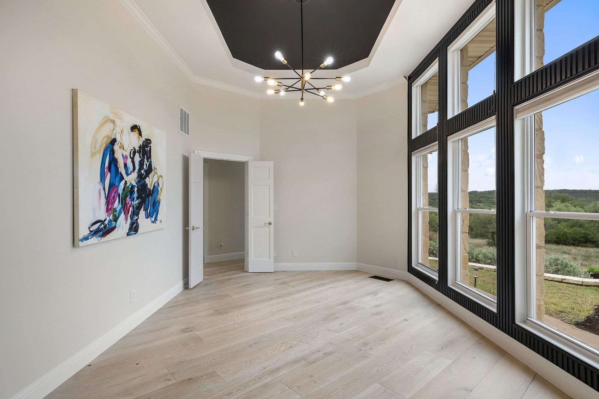 4915 Canyon Ranch Trail Spicewood, TX 78669 - Photo 19 of 40 Simply stunning with the sputnik light highlighting the tray ceiling.