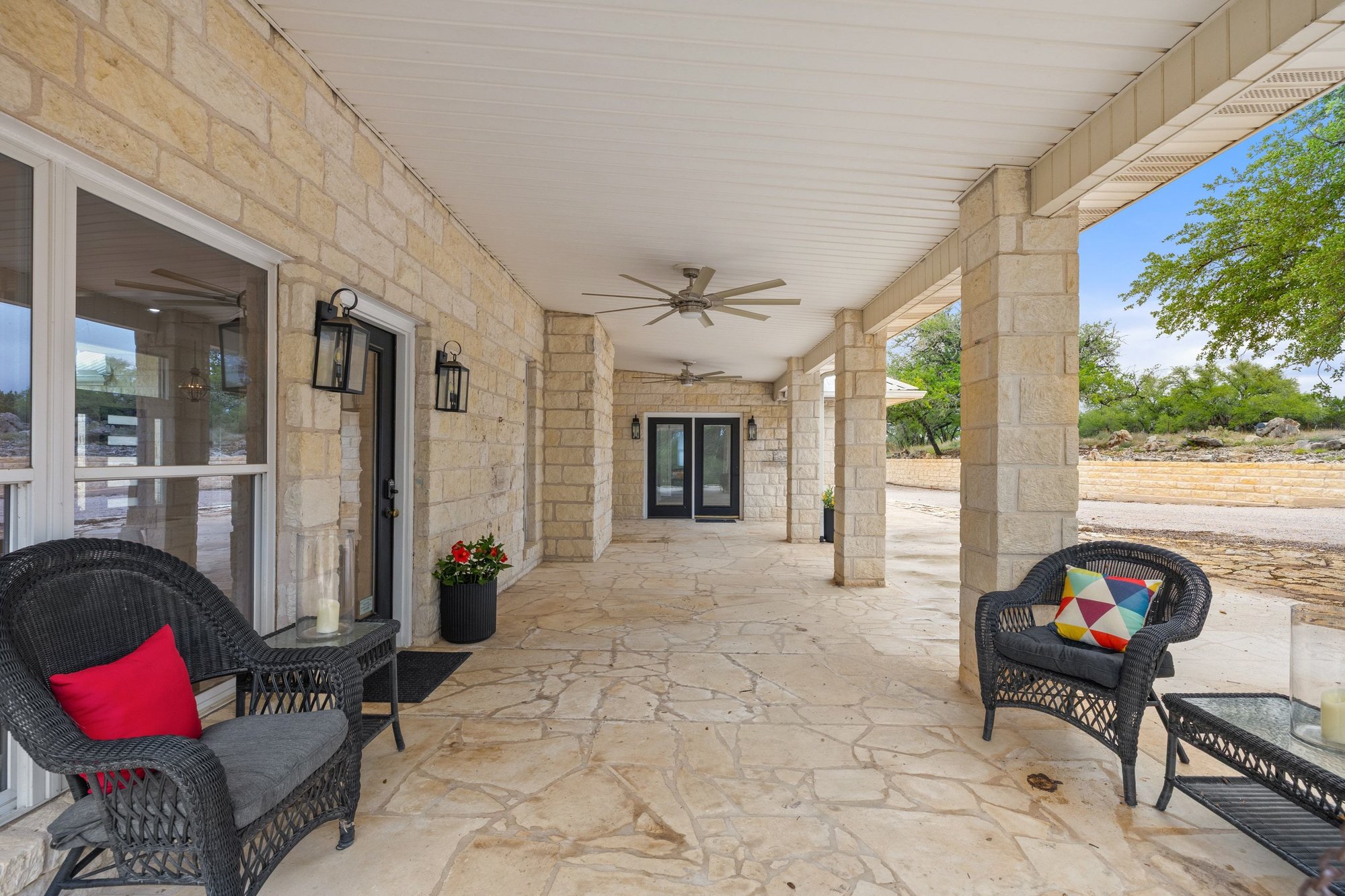 4915 Canyon Ranch Trail Spicewood, TX 78669 - Photo 29 of 40 Extended covered stone patio perfect for watching your four legged friends roam!