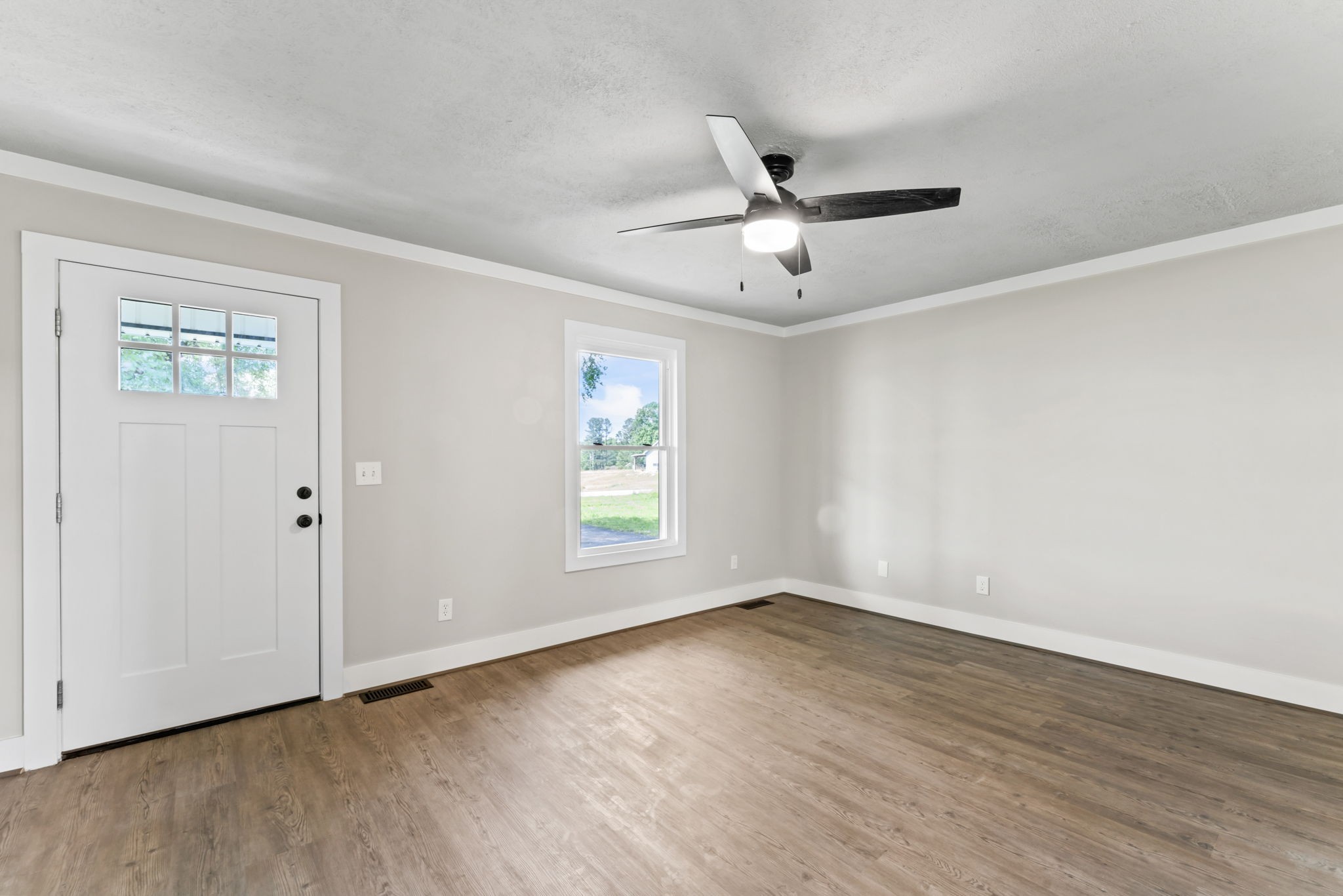 1950 Norton Road Lawrenceburg, TN 38464 - Photo 11 of 43 a view of an empty room with wooden floor and a window