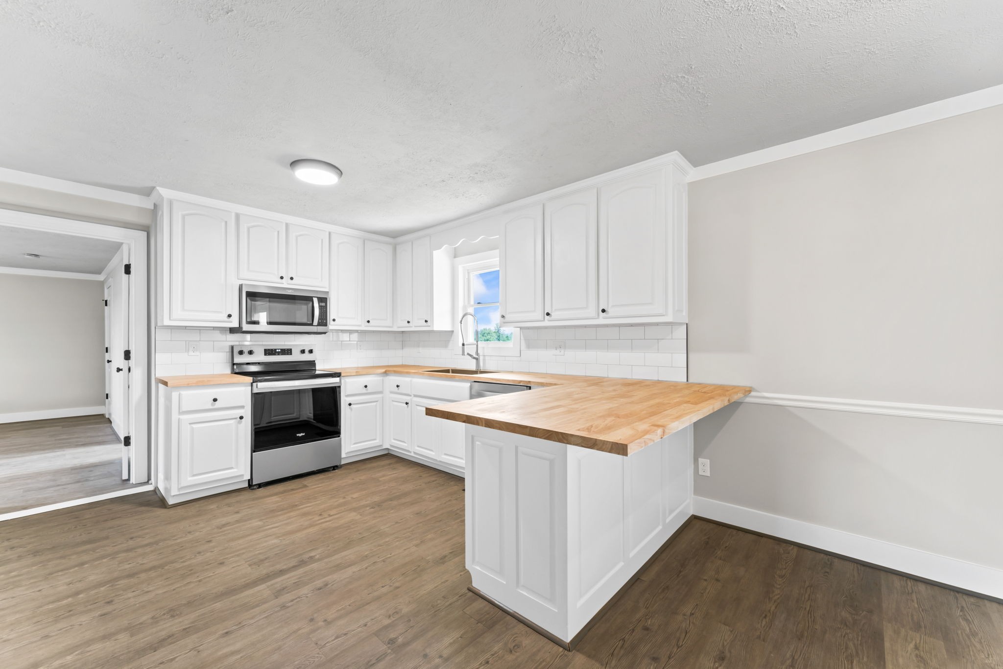 1950 Norton Road Lawrenceburg, TN 38464 - Photo 12 of 43 a kitchen with stainless steel appliances granite countertop a stove top oven a sink and white cabinets