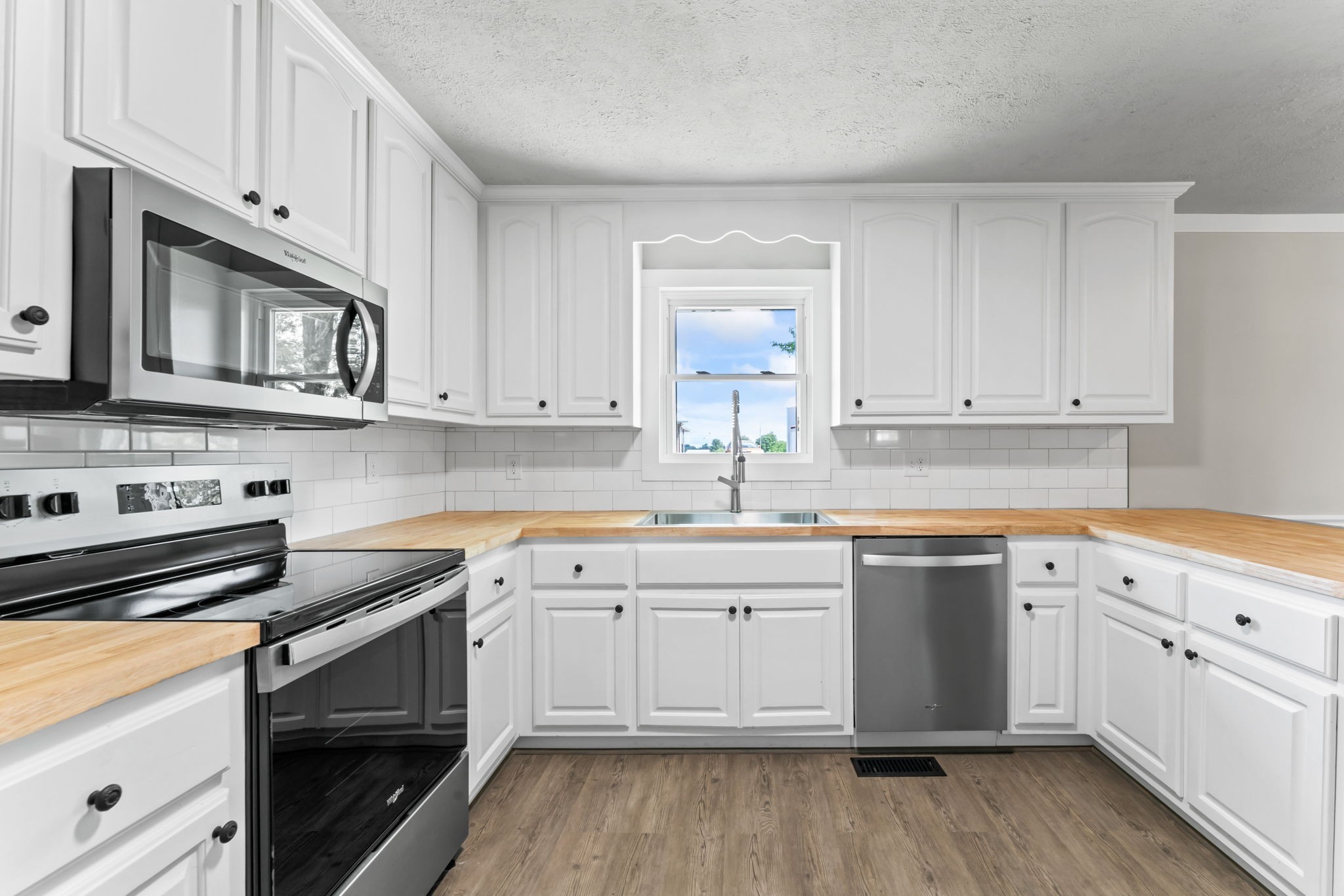 1950 Norton Road Lawrenceburg, TN 38464 - Photo 13 of 43 a kitchen with granite countertop cabinets stainless steel appliances and a wooden floor