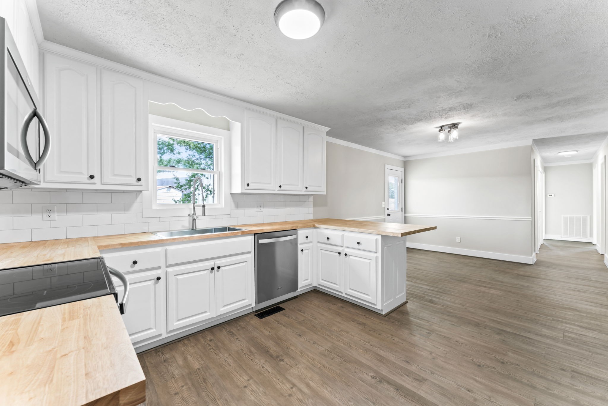 1950 Norton Road Lawrenceburg, TN 38464 - Photo 15 of 43 a kitchen with granite countertop a sink cabinets stainless steel appliances and a window