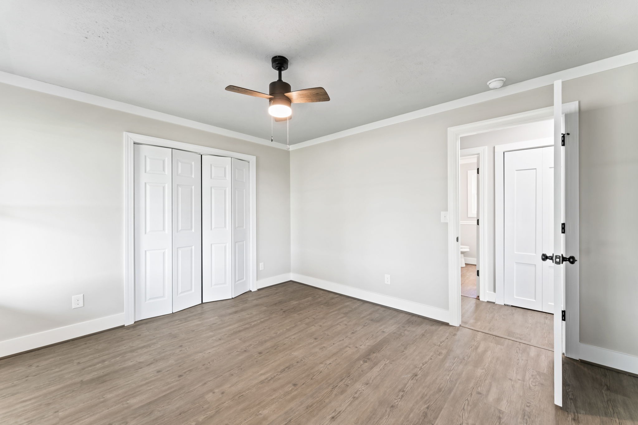 1950 Norton Road Lawrenceburg, TN 38464 - Photo 29 of 43 an empty room with wooden floor ceiling fan and windows