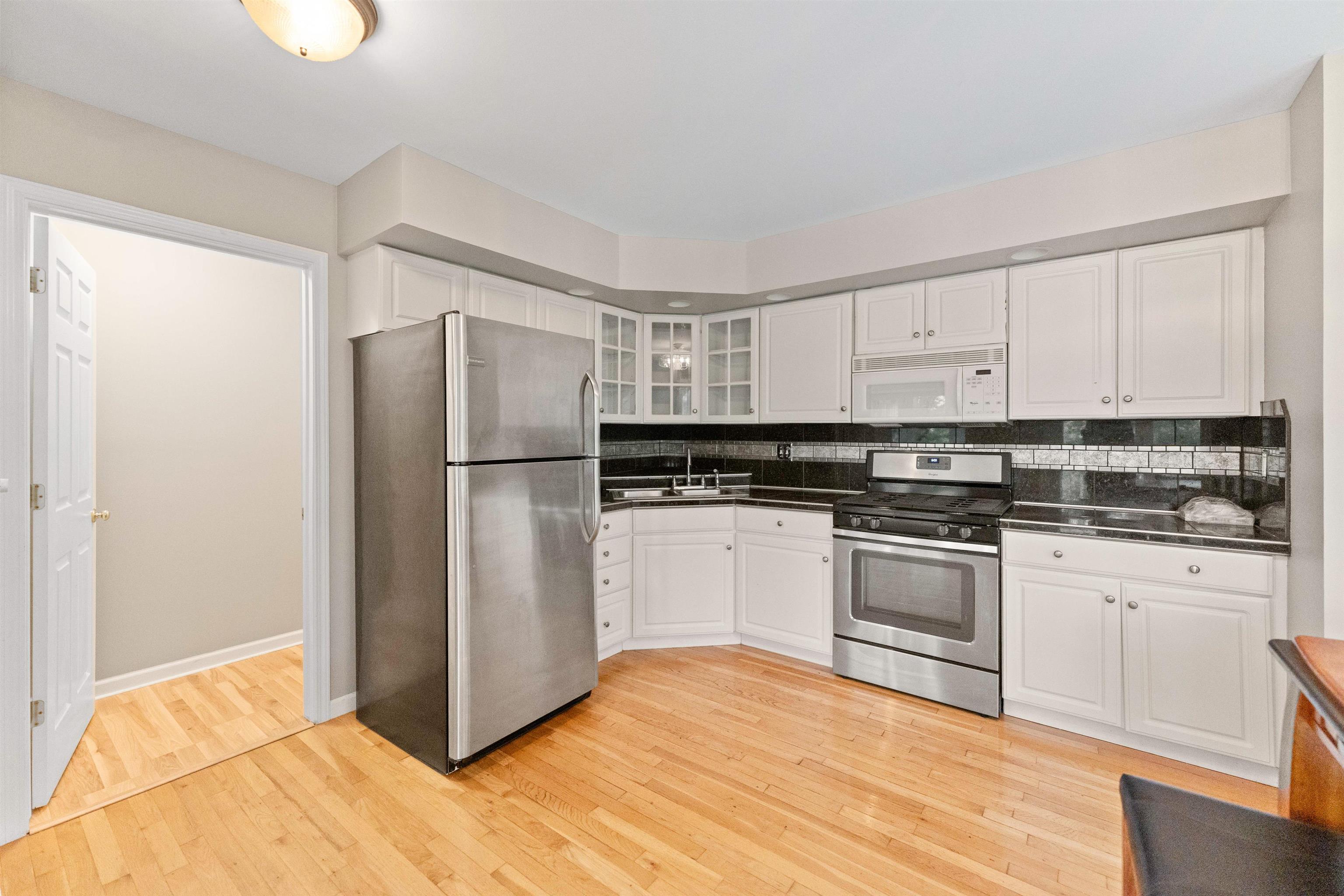 703 Rock Court Dixon, IL 61021 - Photo 15 of 42 a kitchen with granite countertop a refrigerator and a stove top oven