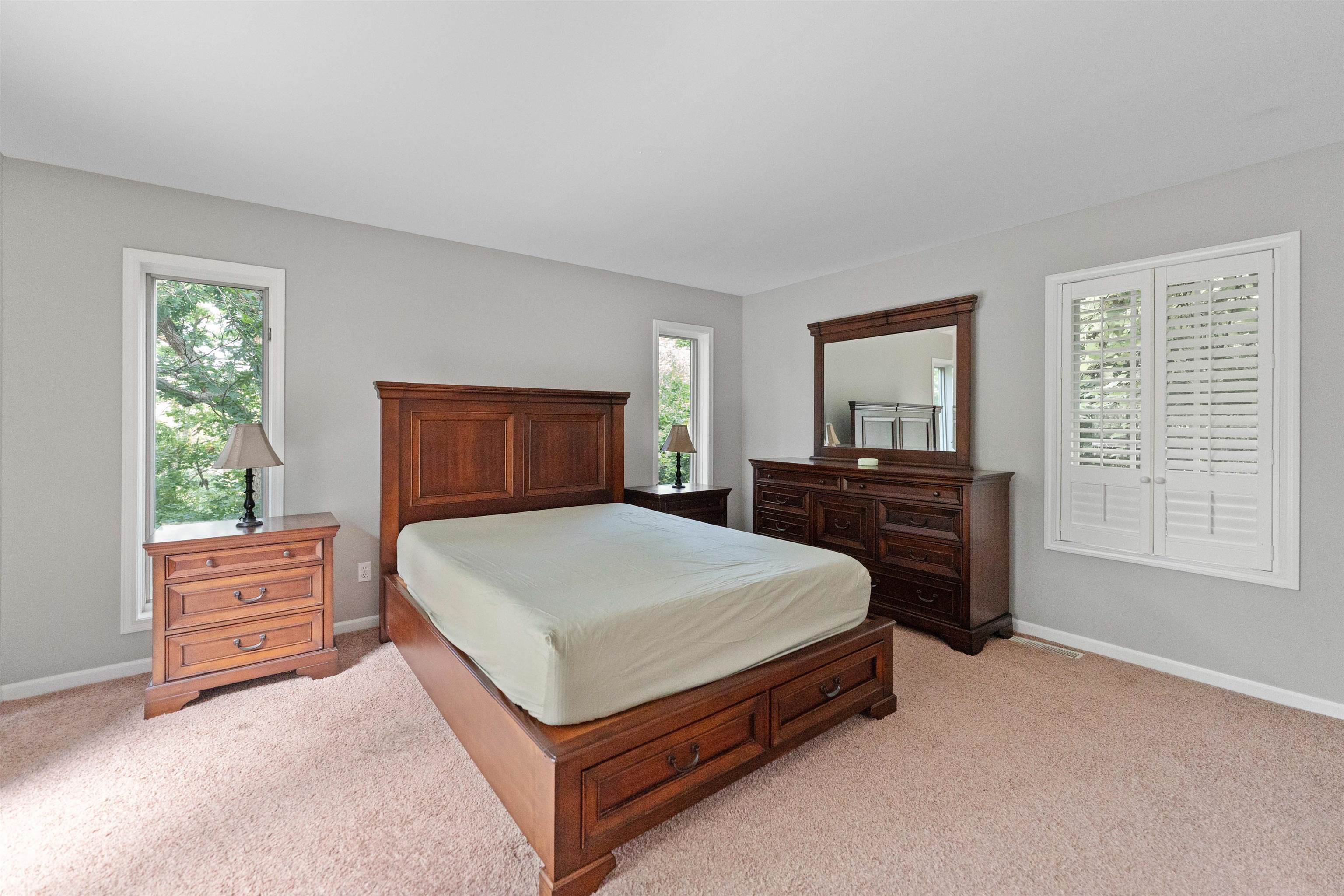703 Rock Court Dixon, IL 61021 - Photo 16 of 42 a spacious bedroom with a bed and a dresser