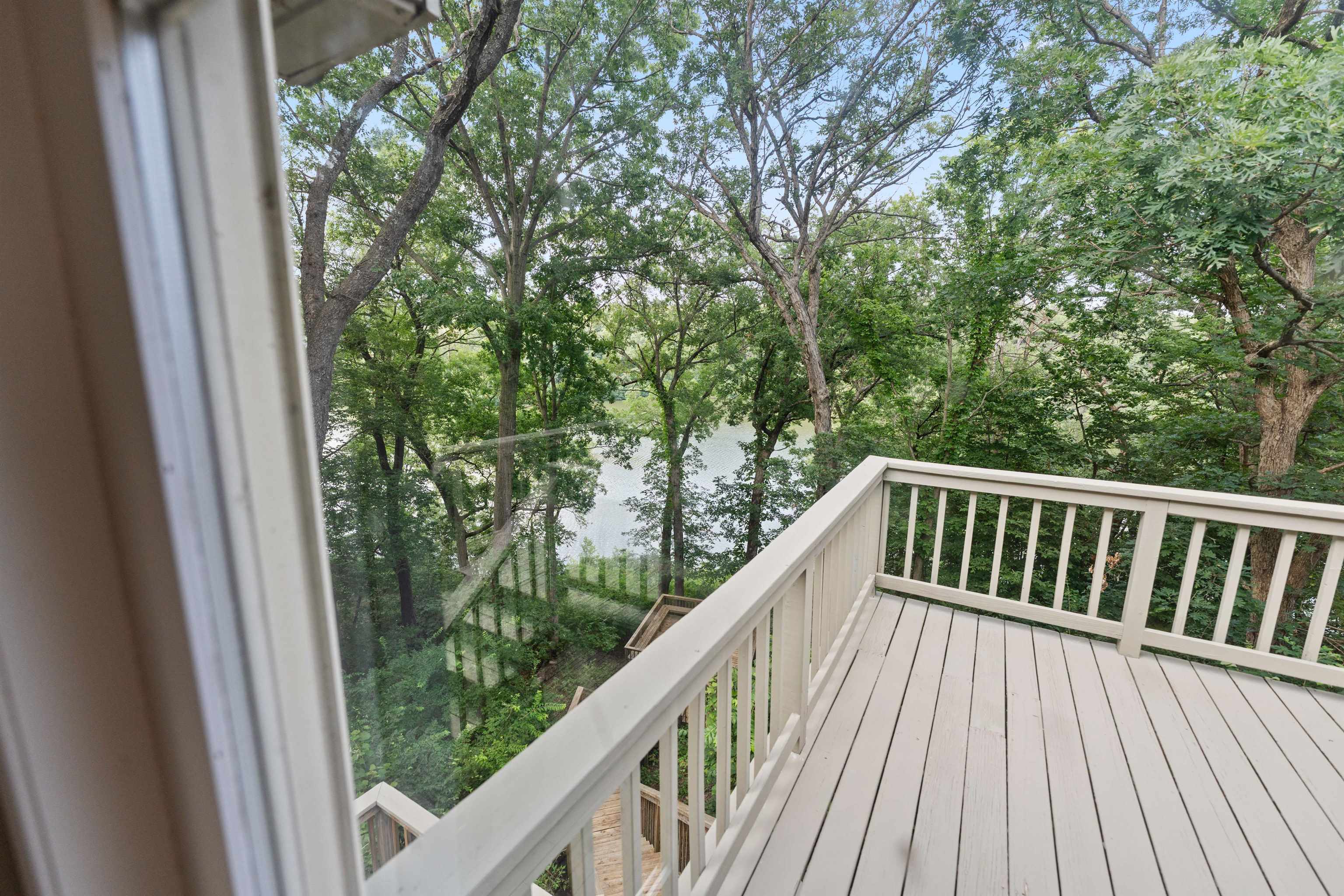 703 Rock Court Dixon, IL 61021 - Photo 21 of 42 a balcony with wooden floor and trees in the back