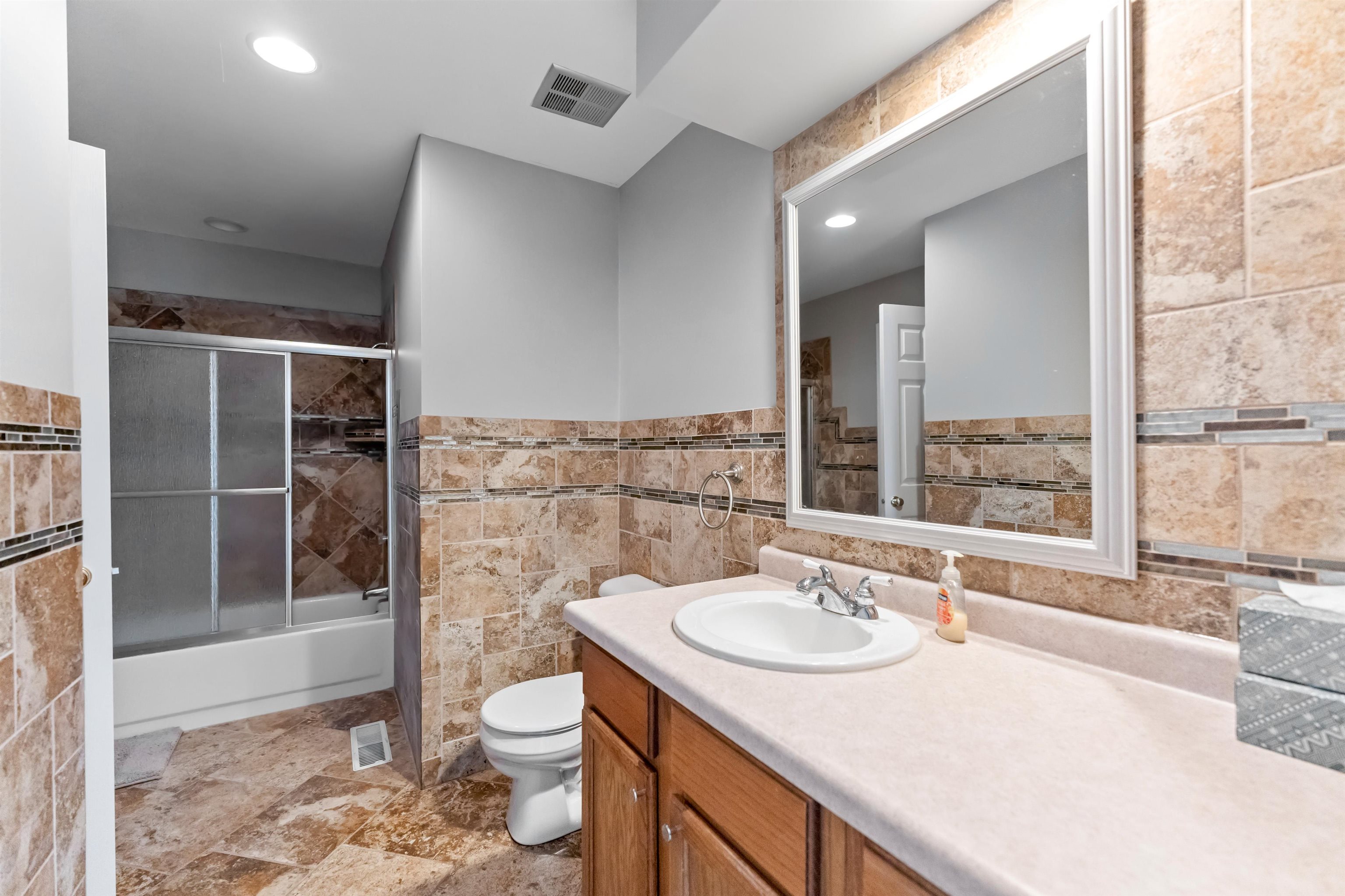 703 Rock Court Dixon, IL 61021 - Photo 24 of 42 a bathroom with a granite countertop sink toilet and shower