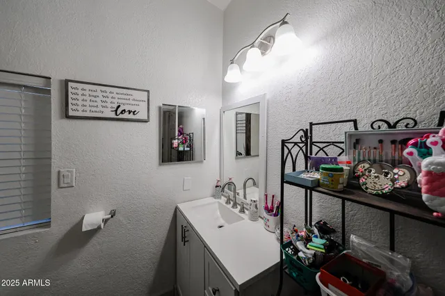a bathroom with a sink mirror and vanity