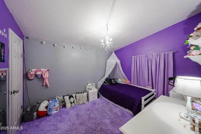 a bedroom with furniture and a lamp