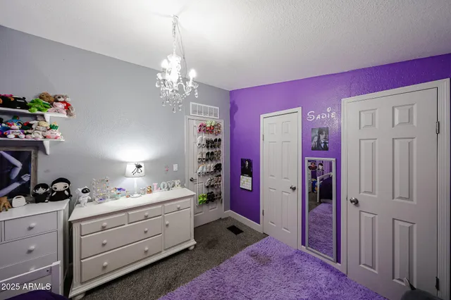a spacious en suite bathroom with a double vanity sink mirror and bedroom