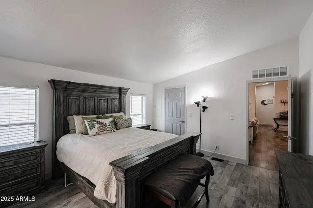 a bedroom with a bed and a mirror