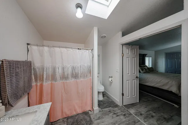 a view of a bedroom with wooden floor and bedroom