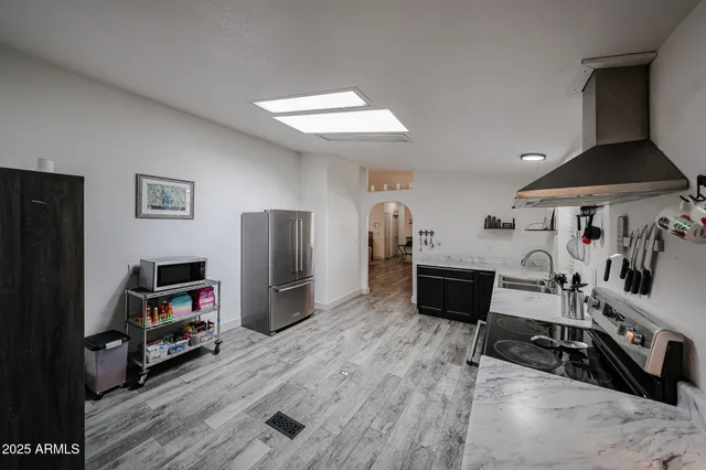 a bedroom with furniture and a flat screen tv