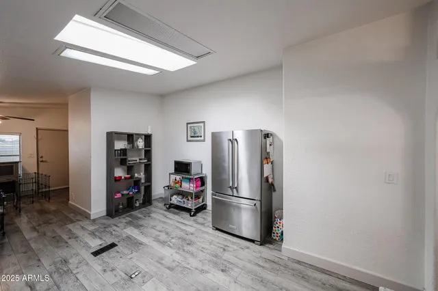 a view of a kitchen with refrigerator and workspace