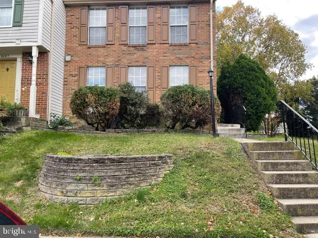 a view of a yard in front of a brick building