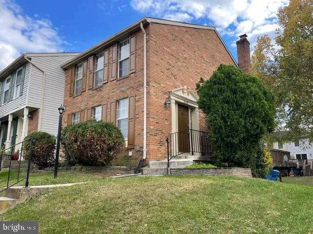 a front view of house with a garden