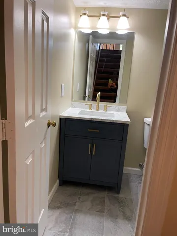 a view of a house with a patio and a yard