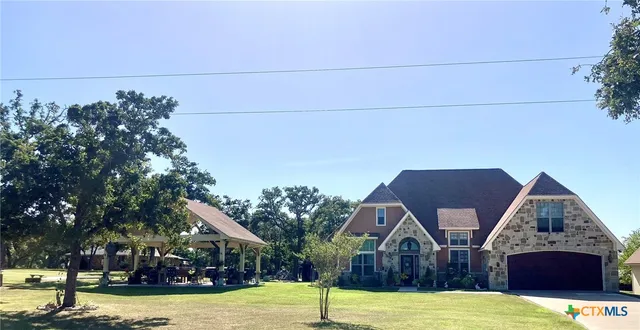 a view of house with yard in front of it