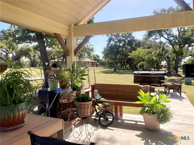 a living room with patio furniture and a potted plant
