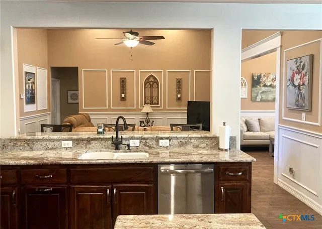 a bathroom with a granite countertop sink a mirror and a bathtub
