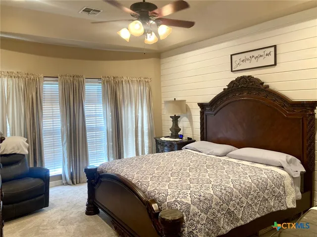 a bedroom with a bed and a couch