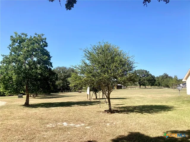 a view of a yard with a tree