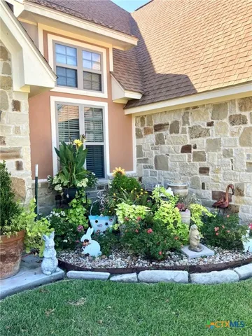 front view of a brick house with a yard