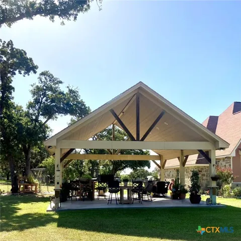 a view of a big building with a big yard and potted plants