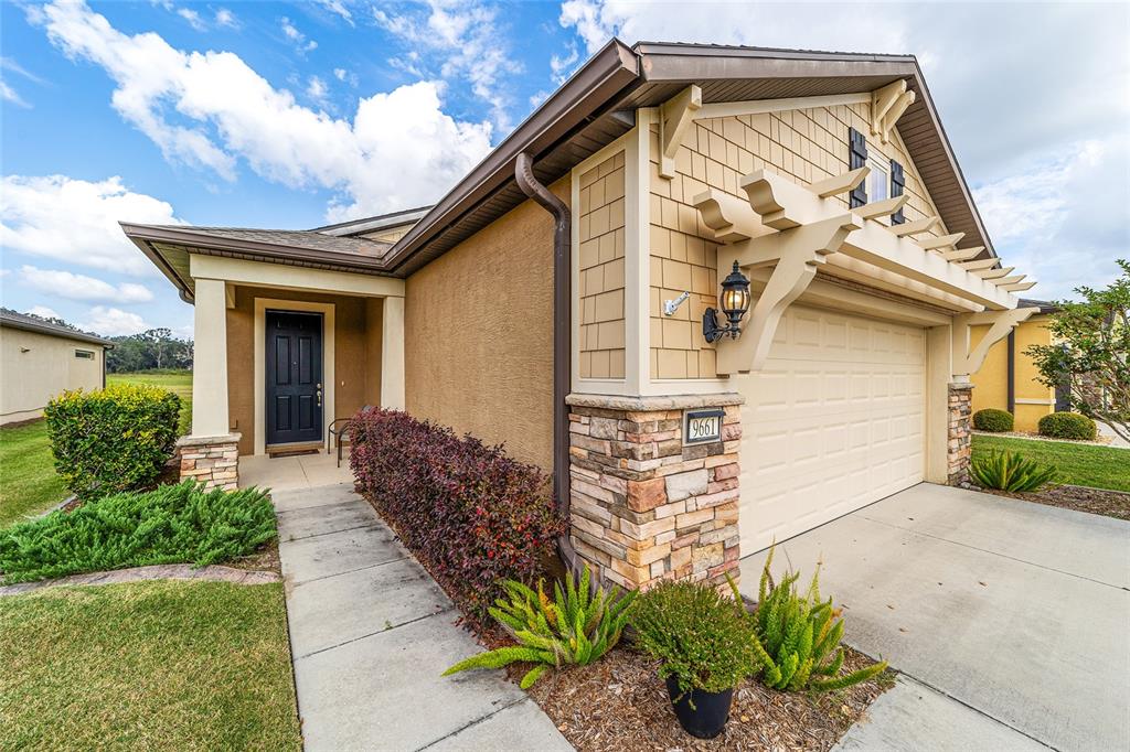 9661 Southwest 63rd Loop Ocala, FL 34481 - Photo 1 of 1 a front view of a house with garden
