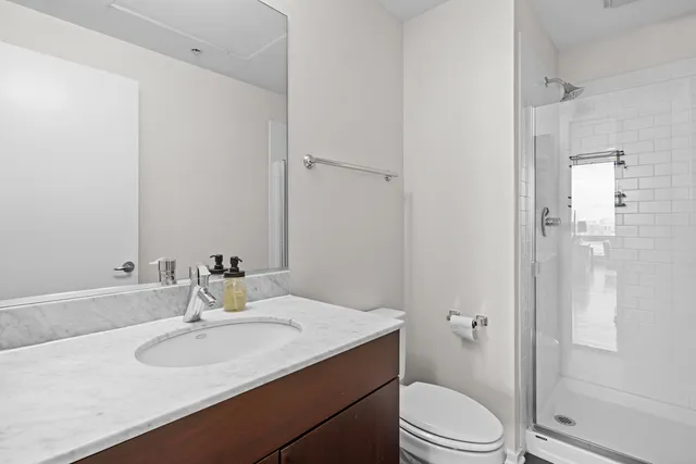 a bathroom with a sink toilet and shower