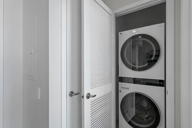 a view of a hallway with washer and dryer