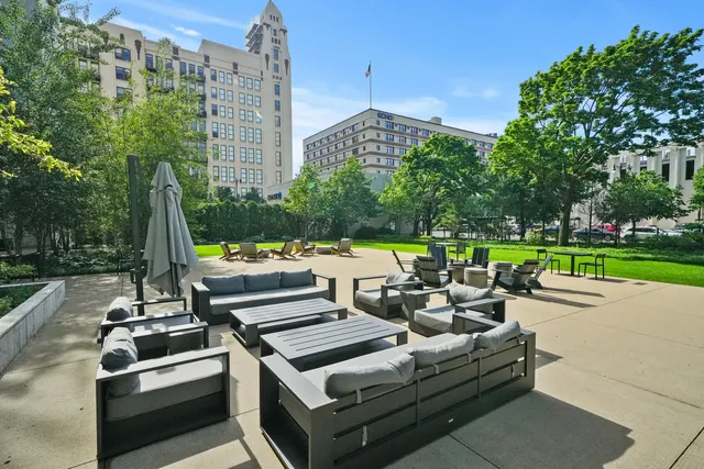 a view of a patio with couches table and chairs and garden