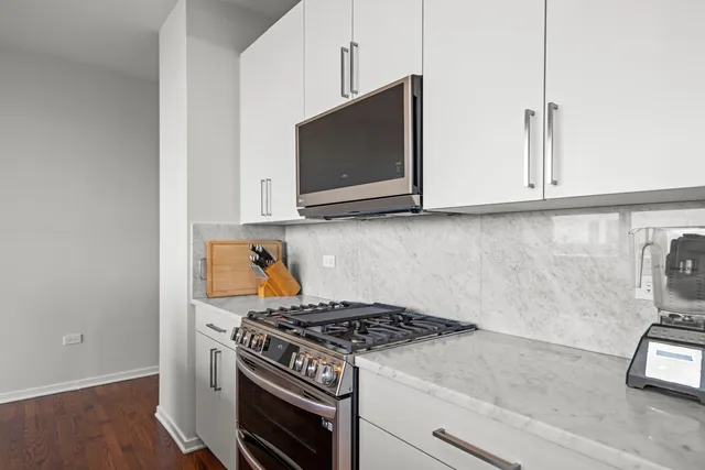 a kitchen with stove top oven and cabinets
