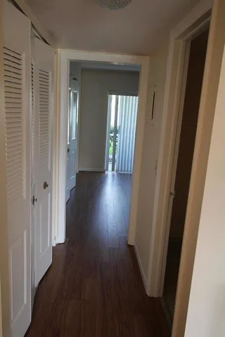 a view of a hallway with wooden floor