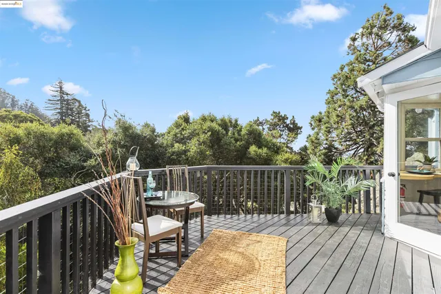 a view of balcony with wooden floor and outdoor seating